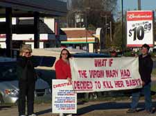 Angela, Angie, & Ken with banner 