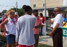 Angela & Pastor Clenard Childress of LEARN counsel Valarie & Jason outside Hope Clinic during Vision for Victory event