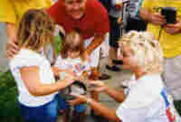Isabella, Sara, Pastor Steve as Angela collects bail money in cap outside Granite City jail.