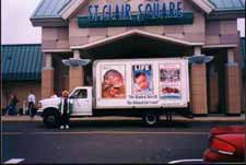 Angela Michaels stands by the Truth Truck greeting shoppers - Click image for larger view