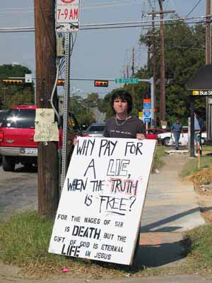 Kyle from Teen Mania holds a sign. Kyle used to practice Wicca until Jesus set him free!