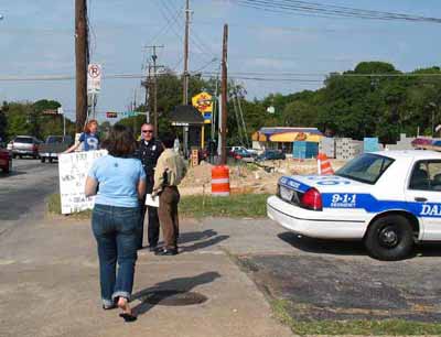 John and the officer speak while Missi heads over to get the officer's identification