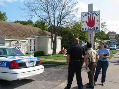 John, Missi and the police officer confer with each other.